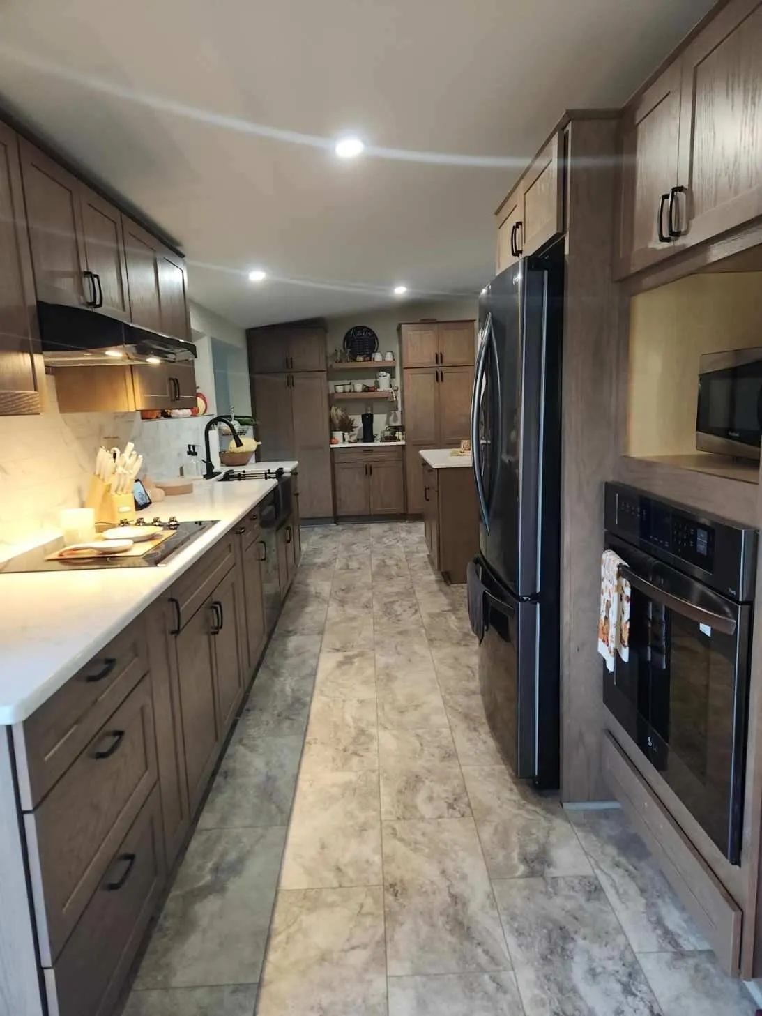 A kitchen in a mobile home with a stove and refrigerator.